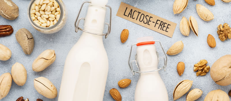 Two bottles of milk with a lactose free sign